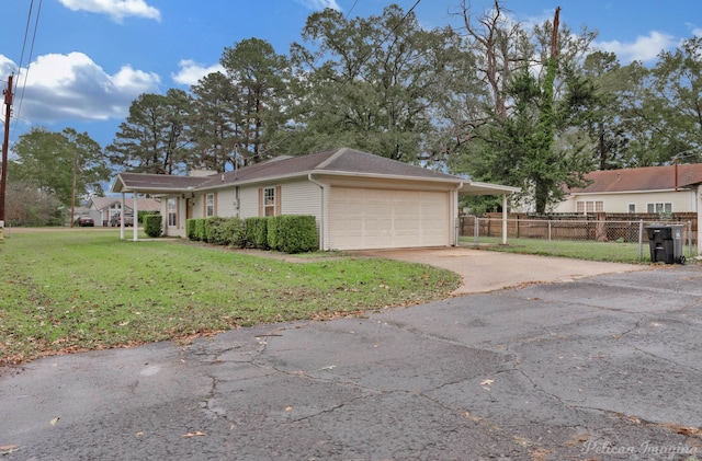 view of front of house with a front yard and a garage