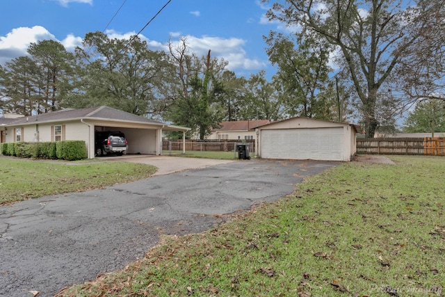 view of side of property featuring a garage, a yard, and a carport