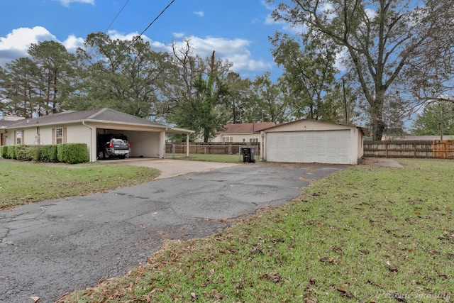 101 W Jefferson Ave, Haughton, LA 71037 - view of side of home with an outdoor structure, a carport, and a detached garage