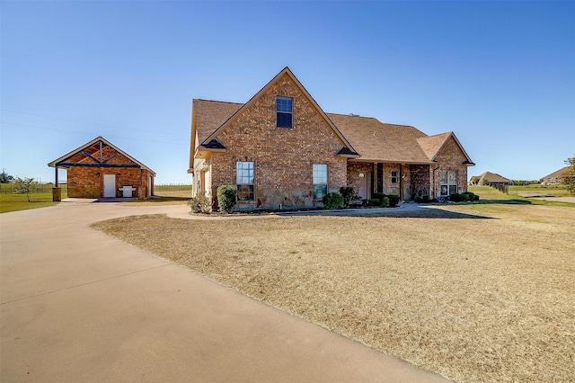 140 Champion Ct, Weatherford, TX 76087 - traditional-style house featuring brick siding, driveway, a front yard, and a shingled roof