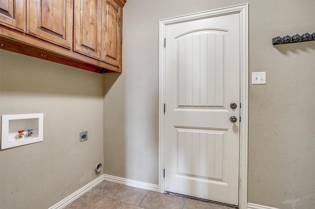 140 Champion Ct, Weatherford, TX 76087 - laundry area featuring cabinet space, electric dryer hookup, washer hookup, baseboards, and light tile patterned flooring