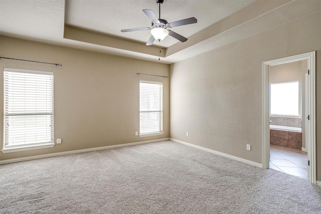 140 Champion Ct, Weatherford, TX 76087 - unfurnished room featuring carpet floors, healthy amount of natural light, a ceiling fan, a raised ceiling, and a textured ceiling