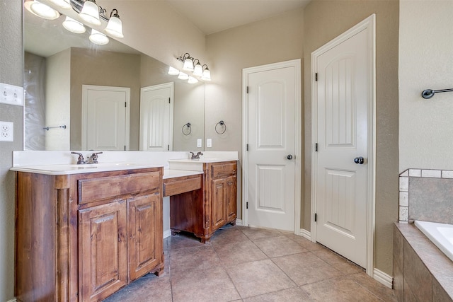 bathroom with tile patterned floors, tiled bath, and vanity