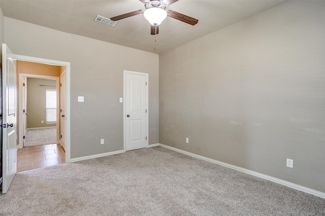 interior space with light carpet and ceiling fan