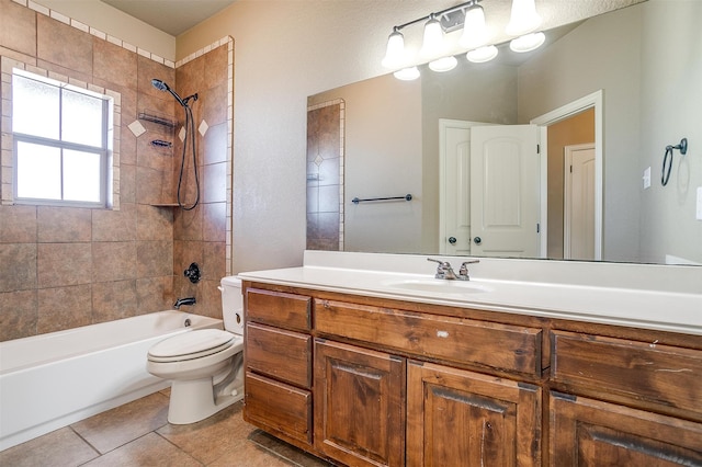 full bathroom with vanity, tile patterned floors, toilet, and tiled shower / bath