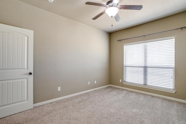 carpeted empty room with a textured ceiling and ceiling fan