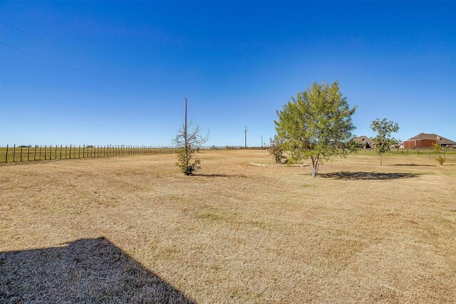 view of yard with a rural view