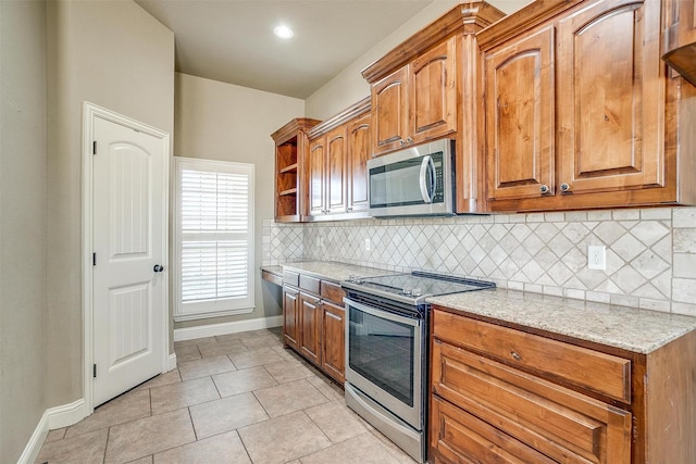 140 Champion Ct, Weatherford, TX 76087 - kitchen with stainless steel appliances, baseboards, tasteful backsplash, open shelves, and light stone counters