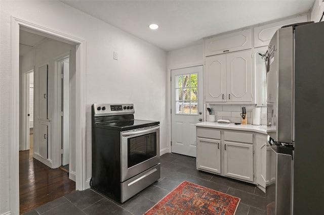 kitchen featuring white cabinets, dark hardwood / wood-style flooring, stainless steel appliances, and backsplash