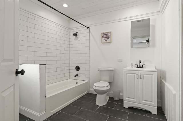 full bathroom featuring vanity, tile patterned floors, tiled shower / bath combo, toilet, and ornamental molding