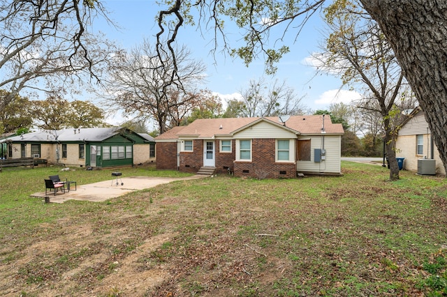 rear view of house featuring a yard, a patio, and central air condition unit