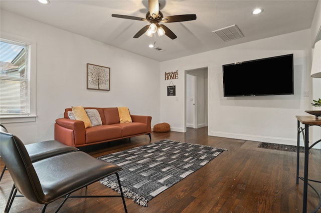 living room with dark hardwood / wood-style floors and ceiling fan