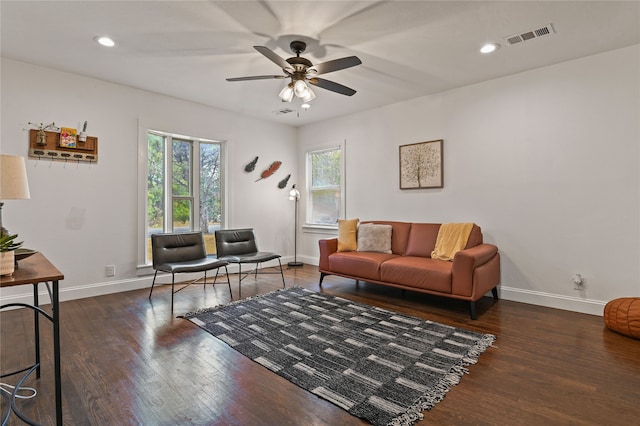 living room with dark hardwood / wood-style floors and ceiling fan