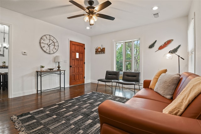 living room featuring ceiling fan and dark wood-type flooring