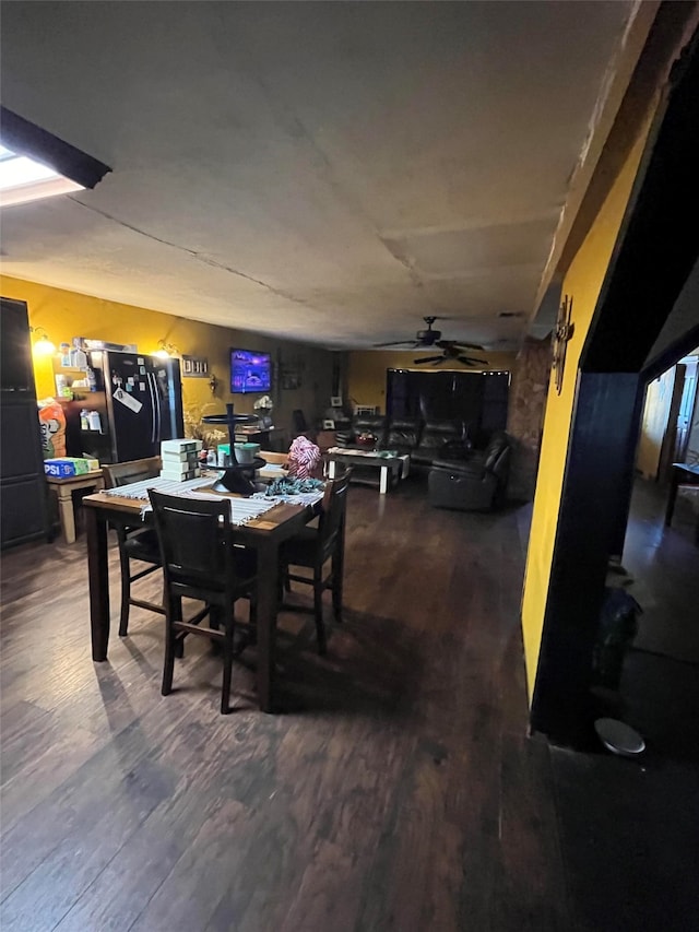 dining space with hardwood / wood-style flooring and ceiling fan