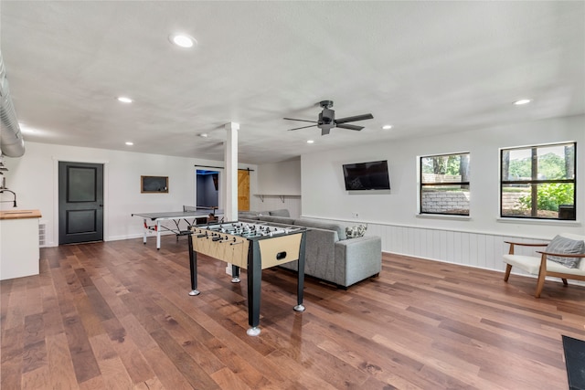 rec room with hardwood / wood-style floors and ceiling fan