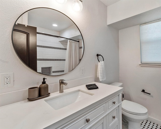 bathroom featuring a shower with curtain, tile patterned flooring, vanity, and toilet