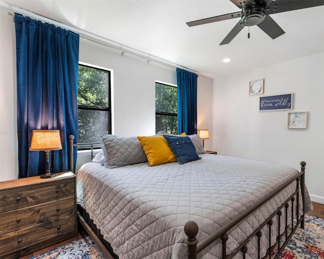 bedroom featuring hardwood / wood-style flooring and ceiling fan