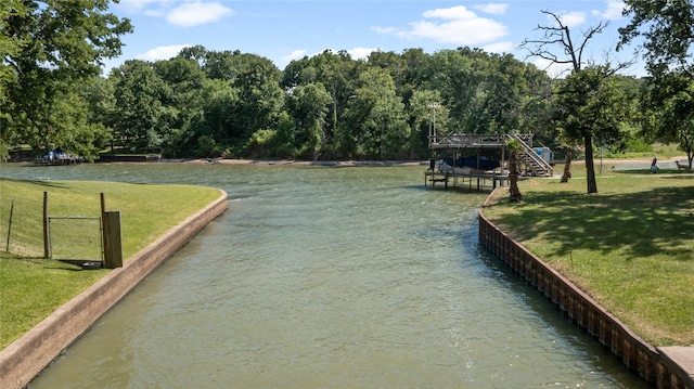 view of property's community featuring a water view and a yard