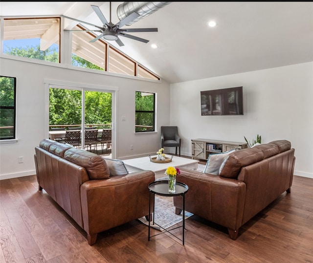 living room featuring dark wood-type flooring, ceiling fan, and high vaulted ceiling