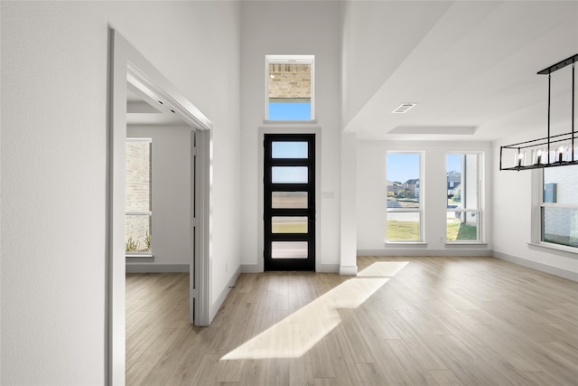 entrance foyer featuring light hardwood / wood-style floors and an inviting chandelier