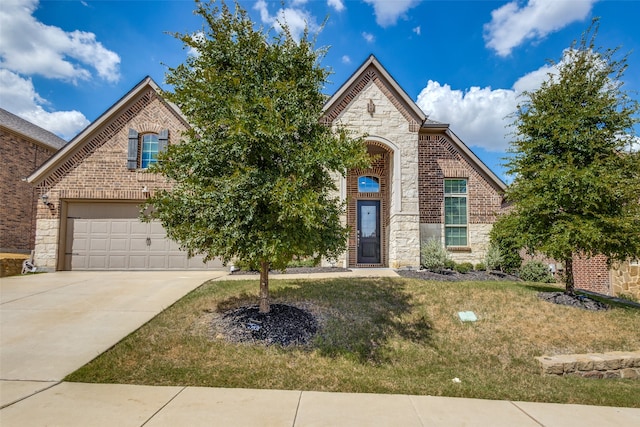 view of front of property with a front yard and a garage