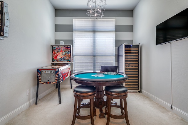 recreation room featuring light colored carpet and wine cooler