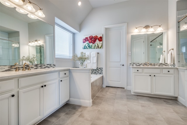 bathroom with vanity, tile patterned floors, separate shower and tub, and lofted ceiling