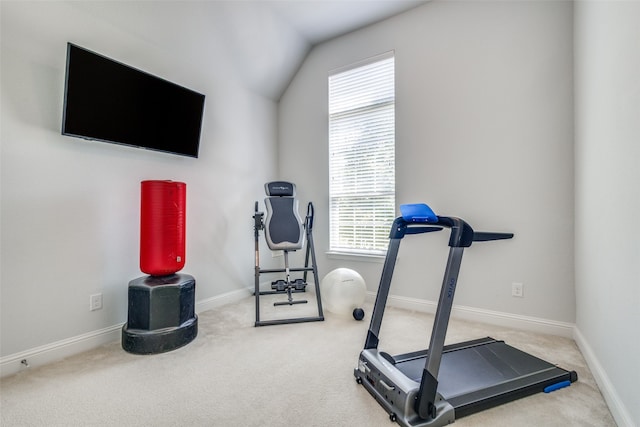 exercise area with a healthy amount of sunlight, vaulted ceiling, and carpet