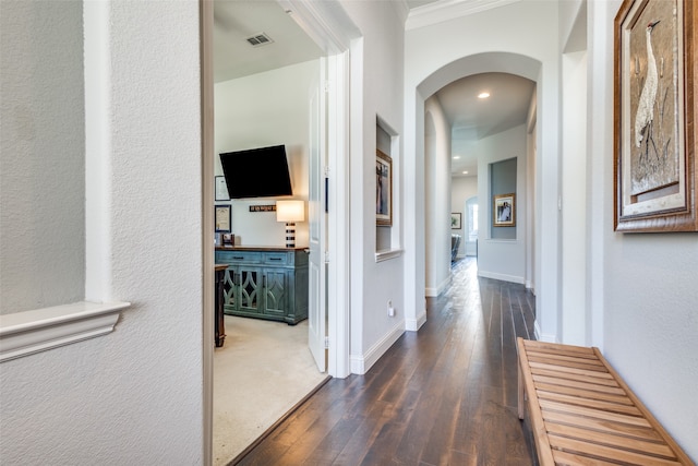 hall featuring dark hardwood / wood-style floors and crown molding