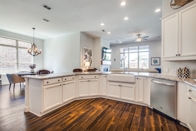 kitchen with dishwasher, white cabinetry, dark hardwood / wood-style floors, and sink