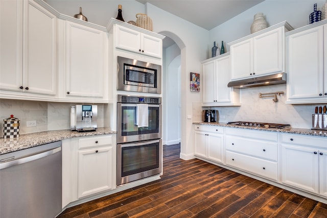 kitchen with white cabinets, stainless steel appliances, and dark hardwood / wood-style floors