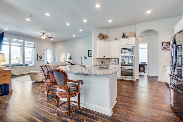 kitchen with white cabinetry, a healthy amount of sunlight, and stainless steel appliances