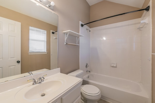 full bathroom with tiled shower / bath, toilet, vanity, and lofted ceiling