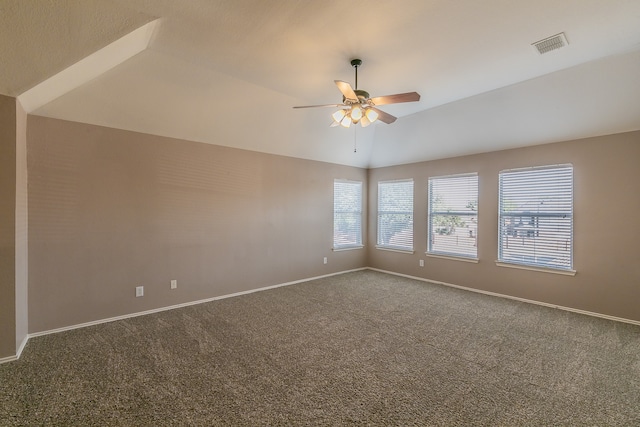 empty room with carpet, ceiling fan, and vaulted ceiling