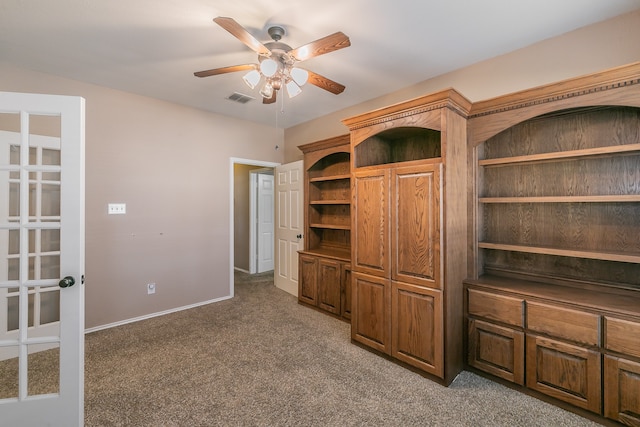 unfurnished office featuring ceiling fan, carpet flooring, and french doors