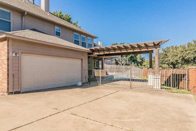 view of front of home featuring a garage and a pergola