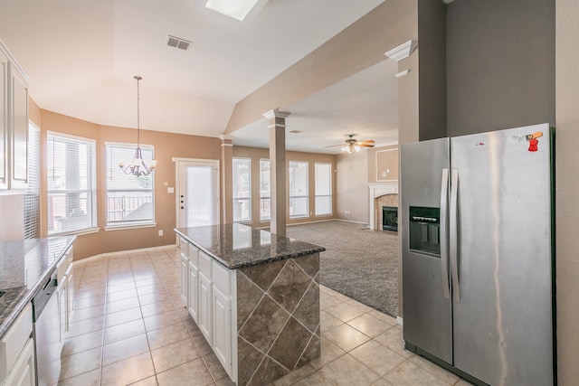 kitchen featuring plenty of natural light, white cabinetry, decorative columns, and stainless steel appliances