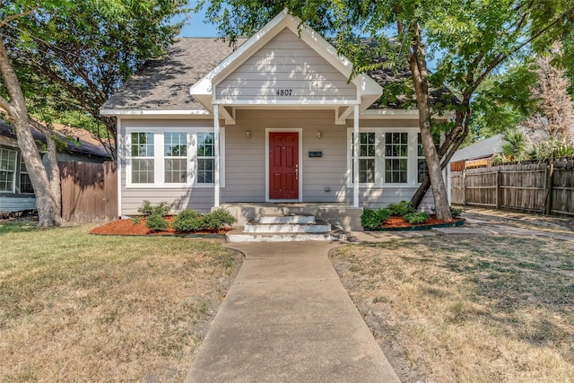 bungalow-style home with a front lawn