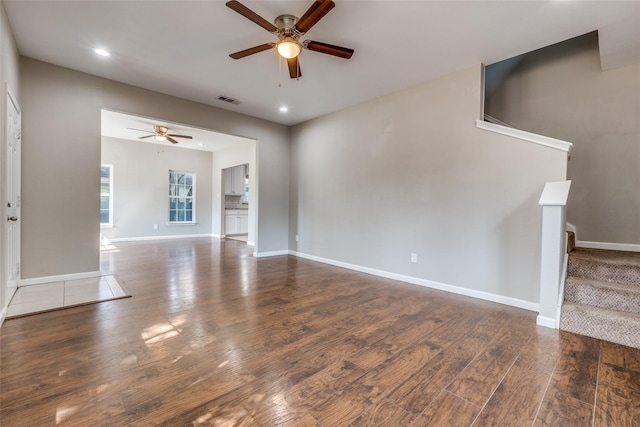 unfurnished living room featuring ceiling fan and wood-type flooring