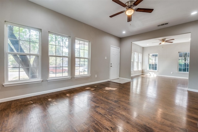 interior space featuring dark hardwood / wood-style flooring, ceiling fan, and a healthy amount of sunlight