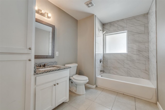 full bathroom featuring toilet, vanity, tiled shower / bath, and tile patterned floors