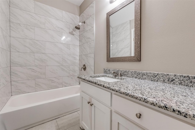 bathroom featuring tiled shower / bath combo, vanity, and tile patterned flooring