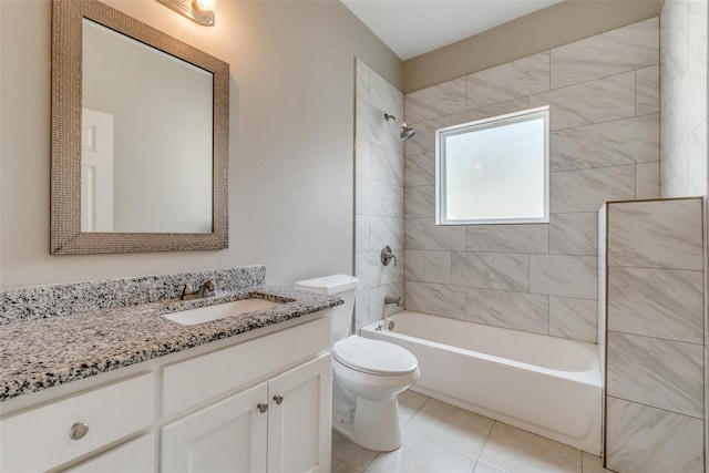 full bathroom featuring vanity, tile patterned flooring, toilet, and tiled shower / bath combo