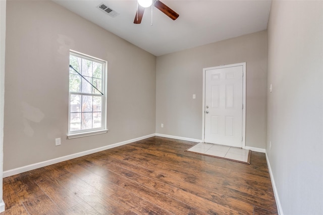 unfurnished room with dark hardwood / wood-style flooring and ceiling fan