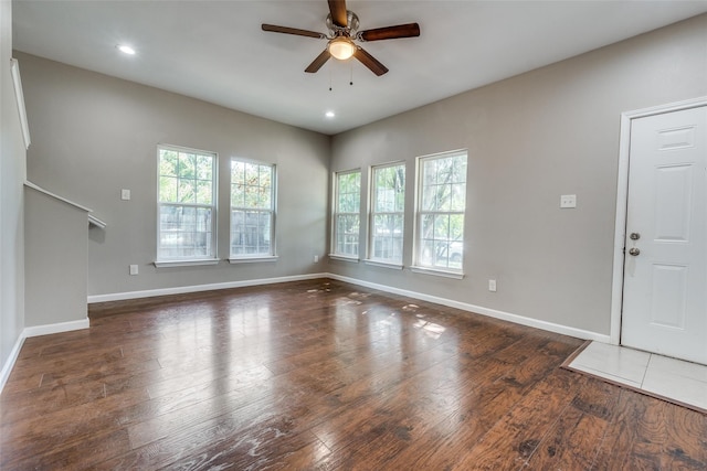 interior space with ceiling fan and dark hardwood / wood-style floors