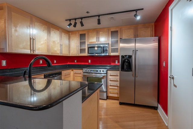 kitchen featuring stainless steel appliances, light hardwood / wood-style floors, light brown cabinetry, and track lighting