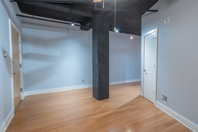 basement with light hardwood / wood-style floors