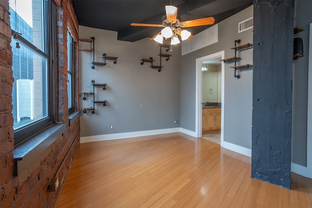 empty room featuring light wood-type flooring and ceiling fan