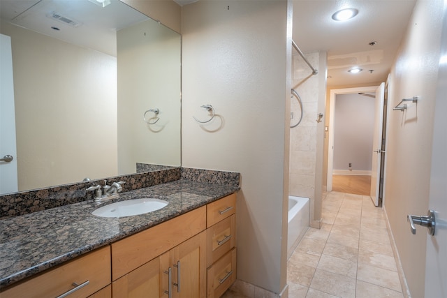 bathroom featuring shower / tub combination, vanity, and tile patterned flooring